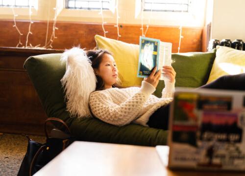 A trinity college student reading in their residence hall