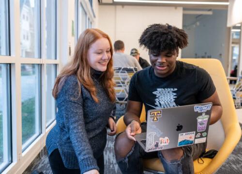 Two Trinity college students engaging in academics